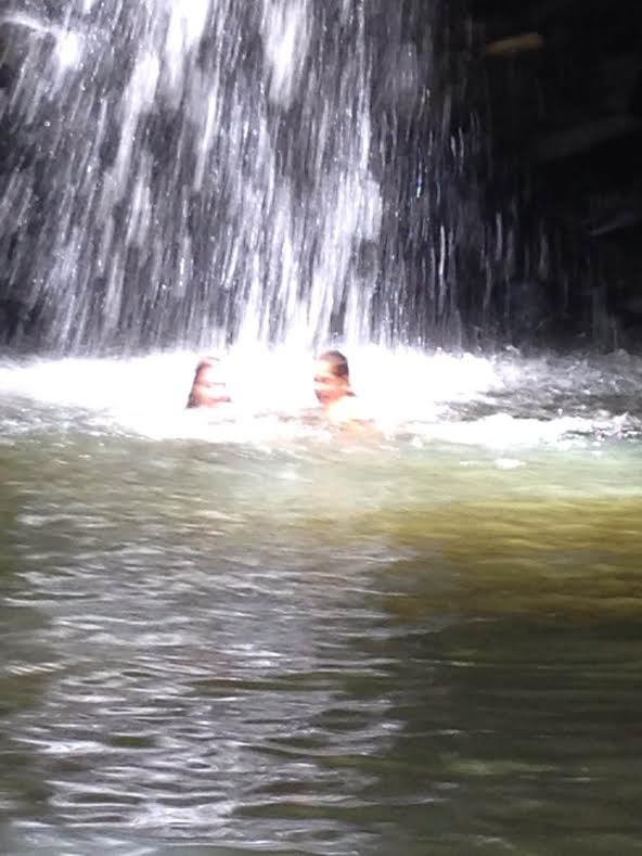 under waterfall