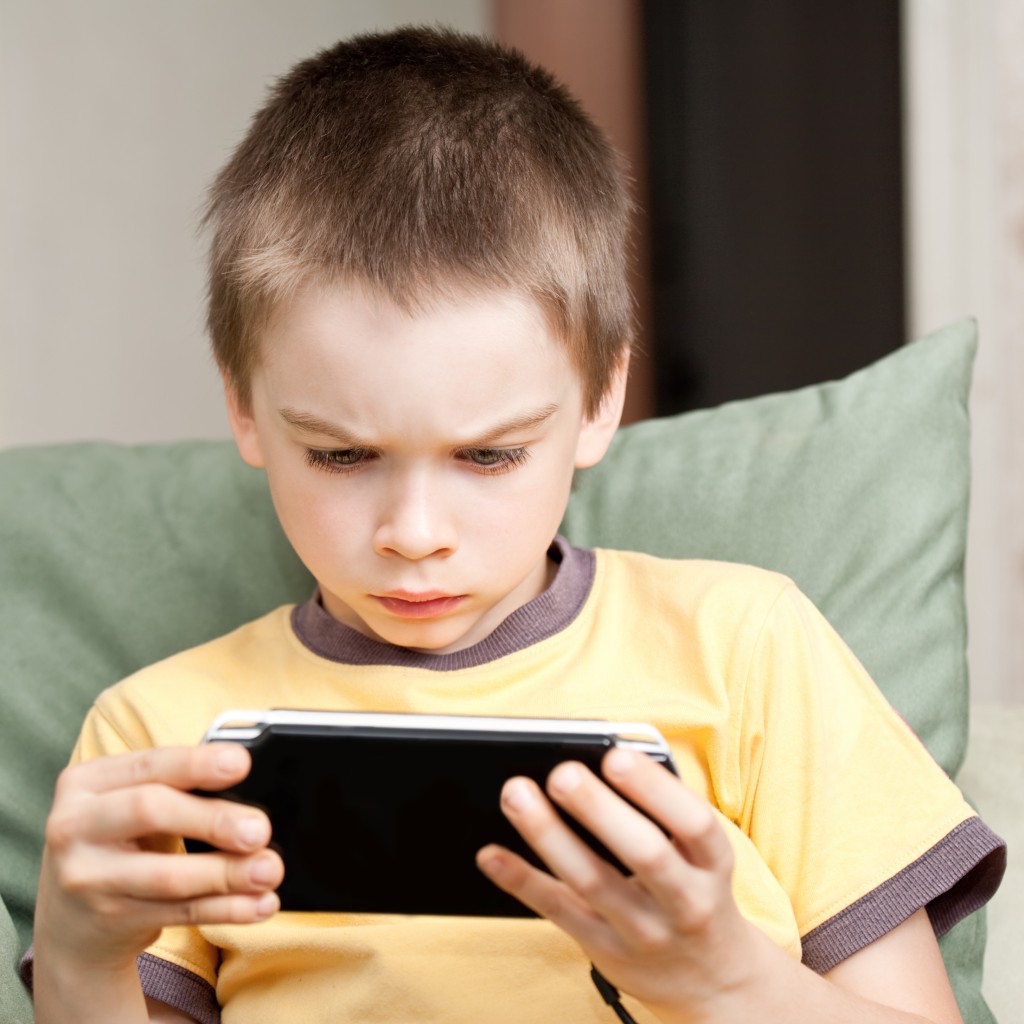 bigstock-Boy-Playing-Game-Console-8012650 (1)