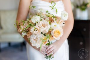 Bride holding a bouquet of roses.