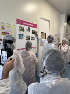 Group in lab coats viewing poster presentation