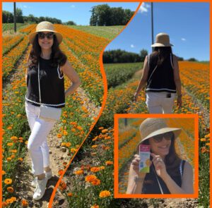 Smiling woman in sunhat in orange flower field